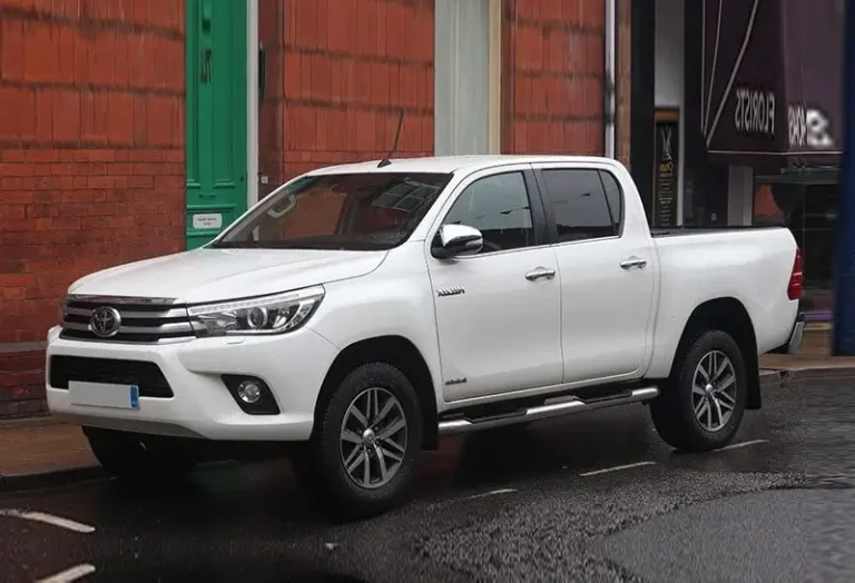White Toyota Hilux Revo 2.8 automatic pickup truck with alloy wheels and rugged design at KK Car Rental